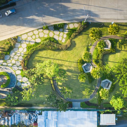 Garden and landscaping in aerial view. Consist of ornamental and decorative object i.e. lawn, grass, building, furniture, tree, bush, flower and fountain. Include paving stone, concrete and asphalt.